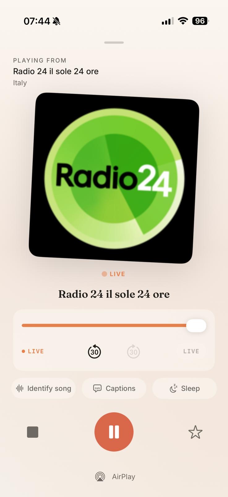 The Now Playing screen for Radio 24 playing live, with live rewind and Identify song, Captions and Sleep controls